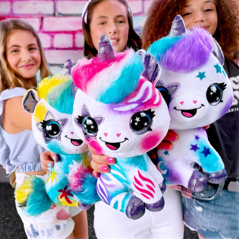 three different painted unicorn soft toys and 3 girls