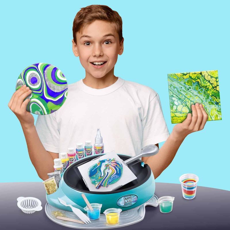 a boy holding canvases painted using the art lab set