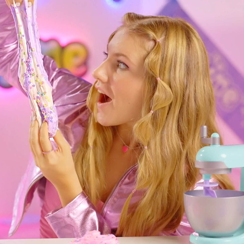 a girl looking amazed at stretchy glittery slime