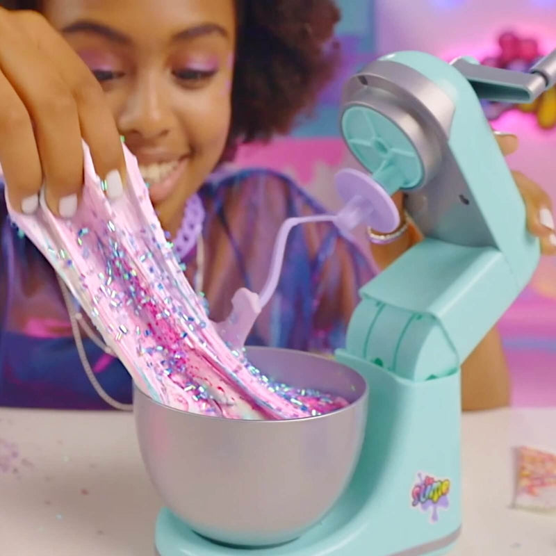 a girl playing with slime in a working mixer toy