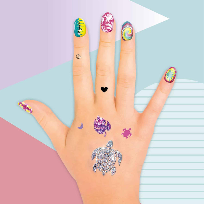 a hand showing a manicure and temporary glitter tattoos