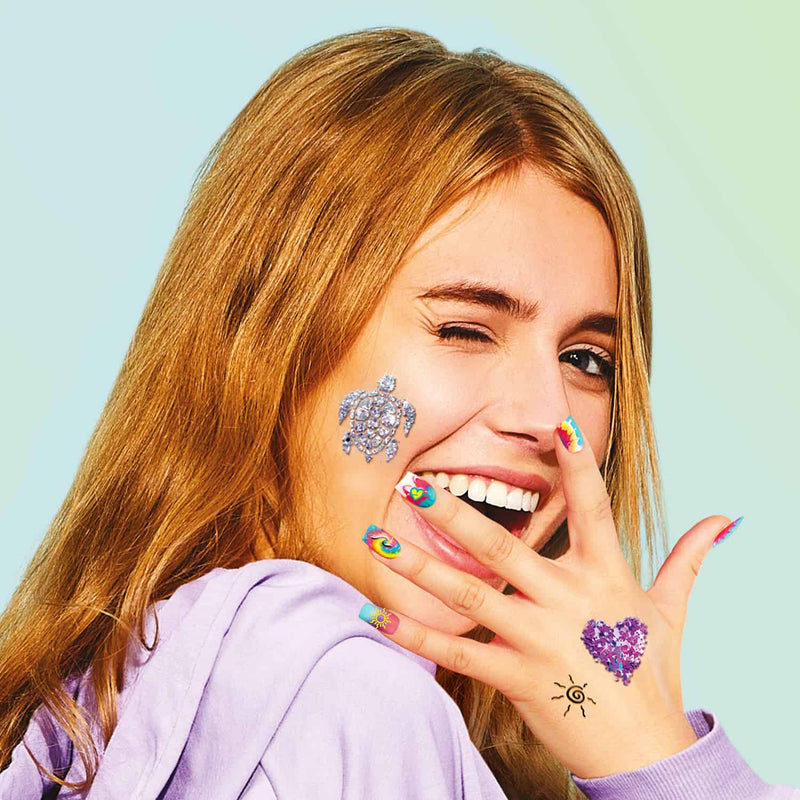 a girl showing her manicured colourful nails and smiling