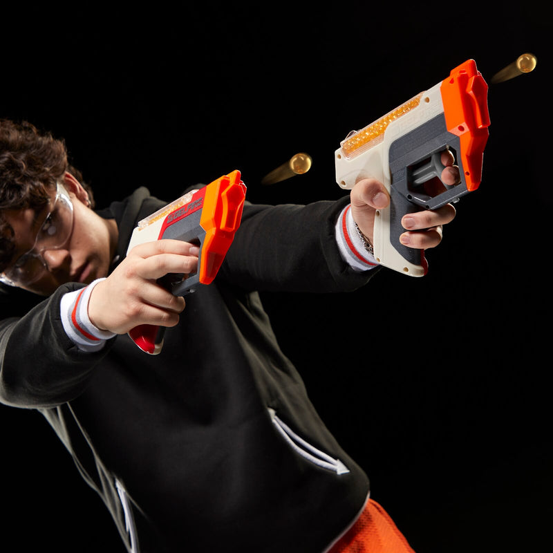 a teenage boy playing with two gelfire blasters