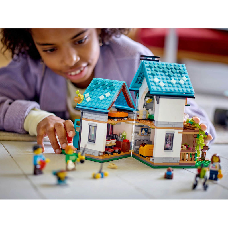 Child playing with Lego house