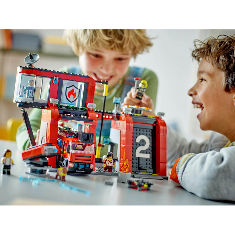 Children playing with lego fire station