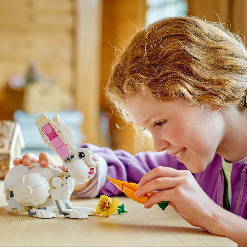 child playing with lego white rabbit and carrot