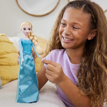photo of a child playing with the frozen elsa 1 doll
