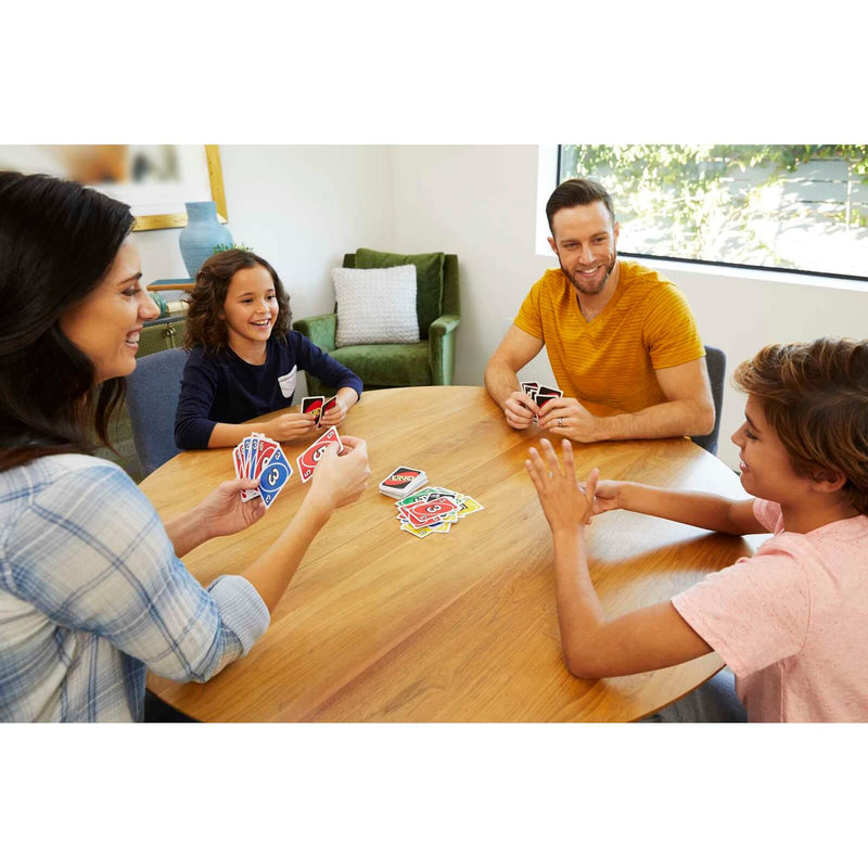 a family of four playing uno card game