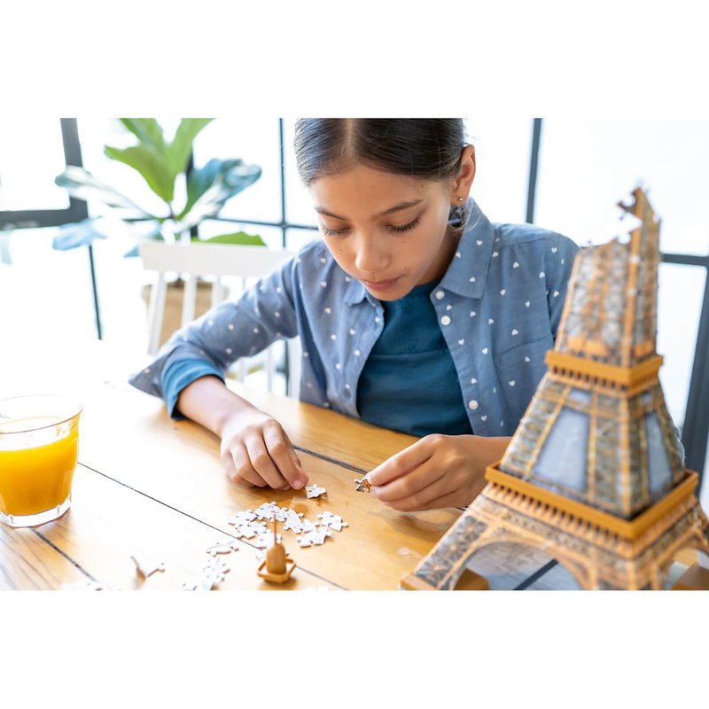 photo of a child building a Ravensburger 3D eiffel tower