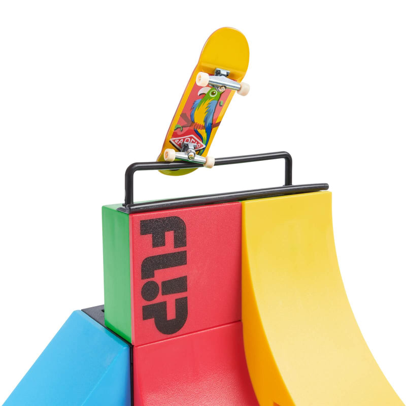 tech deck flip skateboard on the edge of a multicoloured ramp