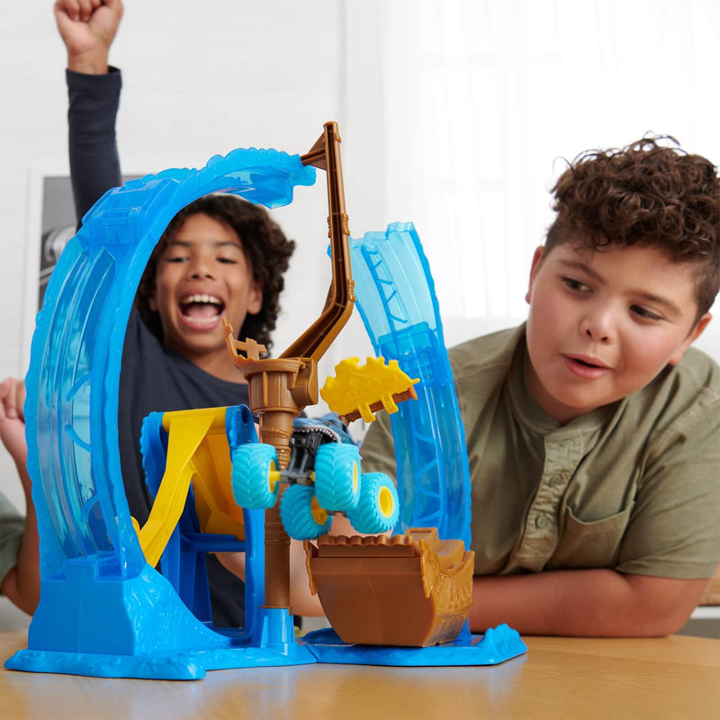 children playing with a blue monster jam loop playset
