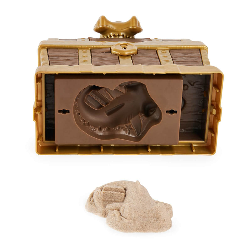 the base of a plastic treasure chest being used as a mold for sand
